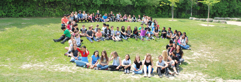 A group of St. Elizabeth Seton Grade 8 students on the grass, forming the number eight.